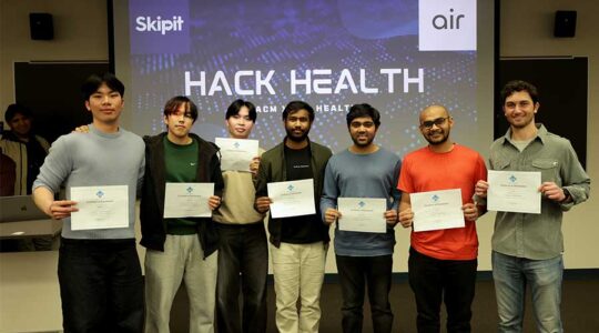 Seven winner at a student-led hackathon hold up their award certificates