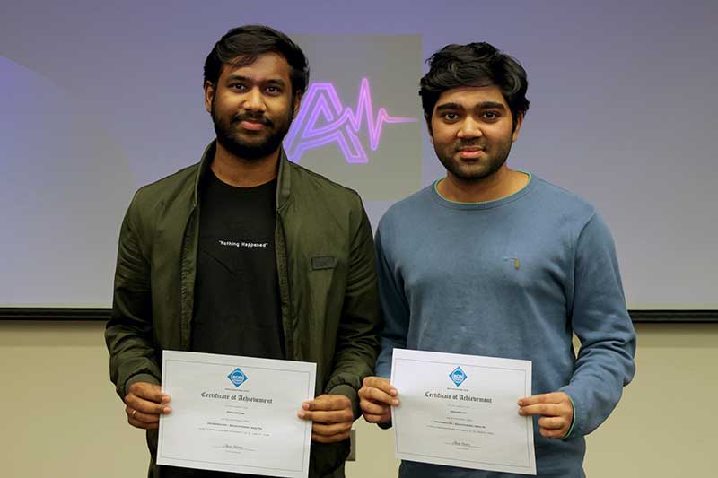 Vamsi Yanamadala (left) and Om Patel hold their certificates