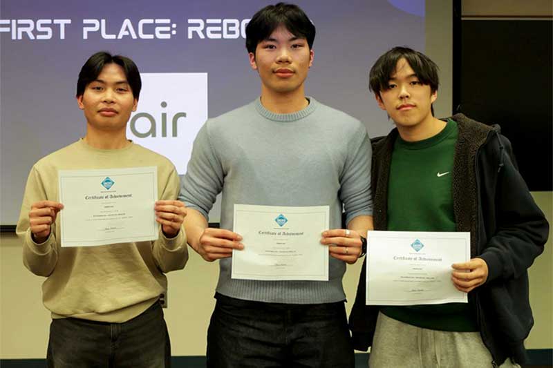 Michael Zhang, Phillips Le, and Nghia Trang hold their award certificates